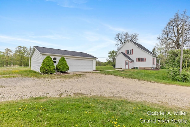 49 E 112th St, Grant, MI 49327 - view of home's exterior featuring a garage, an outbuilding, and a lawn