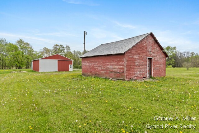 49 E 112th St, Grant, MI 49327 - view of pole building with a lawn