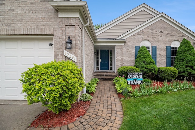 47291 Fairlawn Ct, Canton, MI 48188 - view of exterior entry with a garage, a lawn, and brick siding