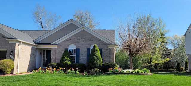47291 Fairlawn Ct, Canton, MI 48188 - view of front of home featuring brick siding, a front yard, and roof with shingles