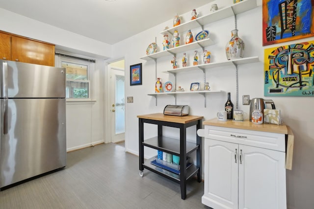 1815 Cooley Ave, Ann Arbor, MI 48103 - kitchen featuring freestanding refrigerator, open shelves, and baseboards