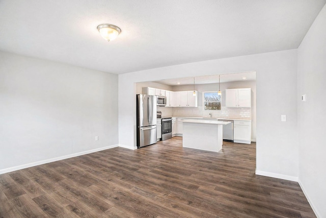 7987 Sierra Dr, Belding, MI 48809 - kitchen featuring appliances with stainless steel finishes, tasteful backsplash, baseboards, light countertops, and dark wood finished floors
