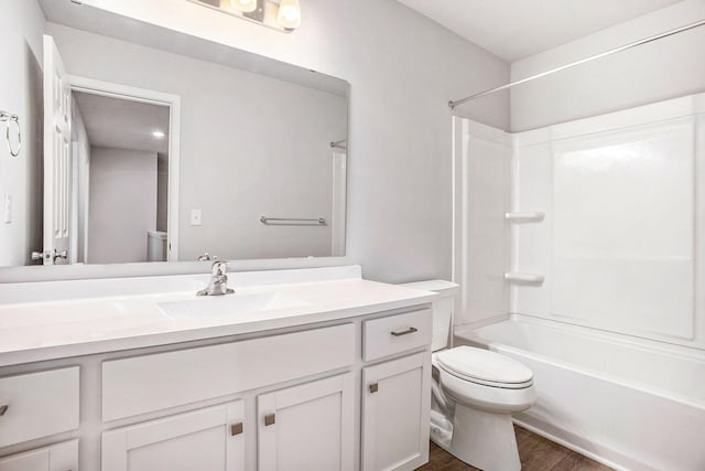 7987 Sierra Dr, Belding, MI 48809 - full bath with toilet, wood finished floors, vanity, and shower / bath combination