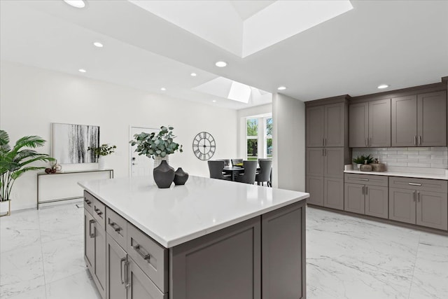 49712 Geddes Rd, Canton, MI 48188 - kitchen with a skylight, gray cabinets, recessed lighting, light countertops, and light marble finish floors