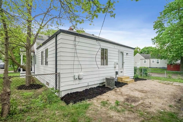 620 2nd Ave, Pontiac, MI 48340 - back of property with fence, central AC unit, and a chimney