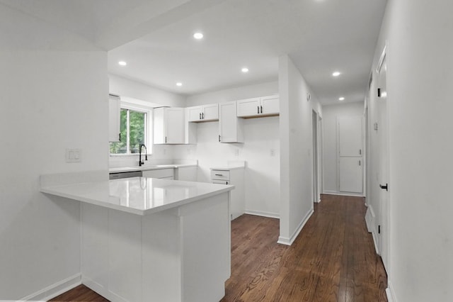 620 2nd Ave, Pontiac, MI 48340 - kitchen featuring a peninsula, white cabinets, a sink, baseboards, and recessed lighting