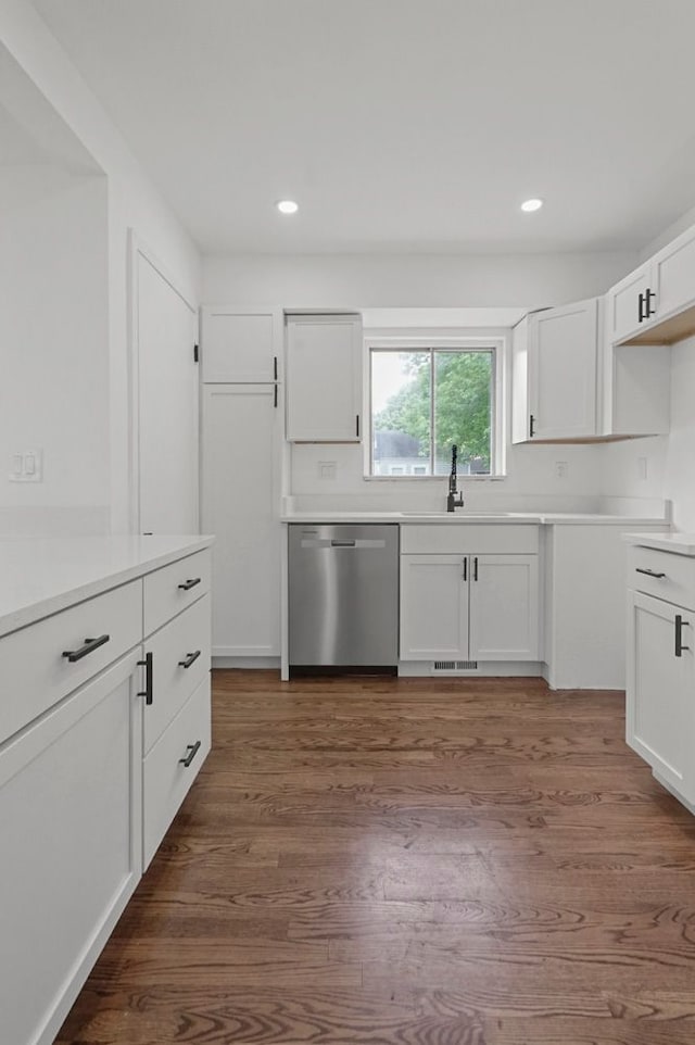 620 2nd Ave, Pontiac, MI 48340 - kitchen with stainless steel dishwasher, a sink, white cabinets, dark wood-style flooring, and recessed lighting