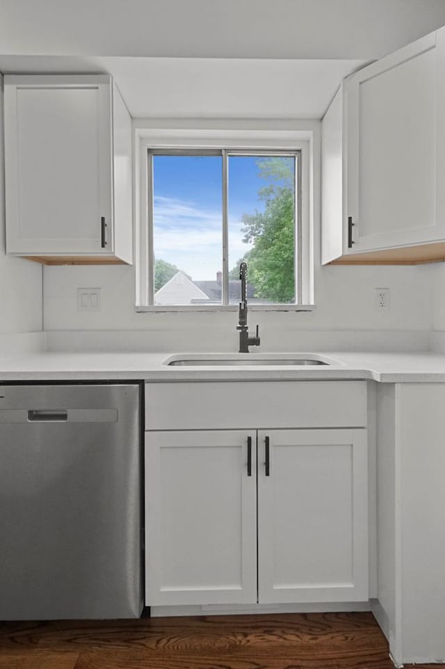 620 2nd Ave, Pontiac, MI 48340 - kitchen with stainless steel dishwasher, a sink, white cabinets, and dark wood-style flooring