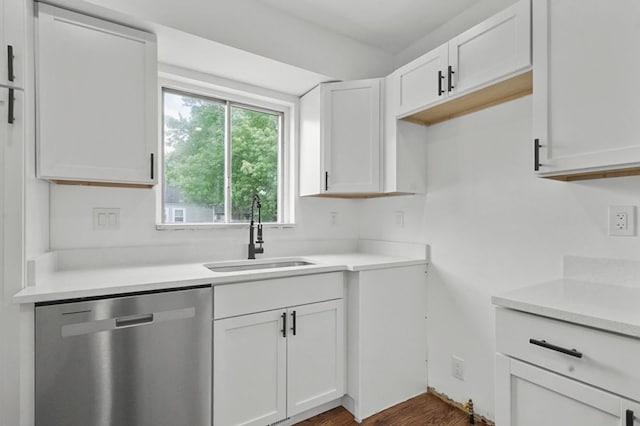620 2nd Ave, Pontiac, MI 48340 - kitchen with stainless steel dishwasher, a sink, light countertops, white cabinets, and dark wood-style floors