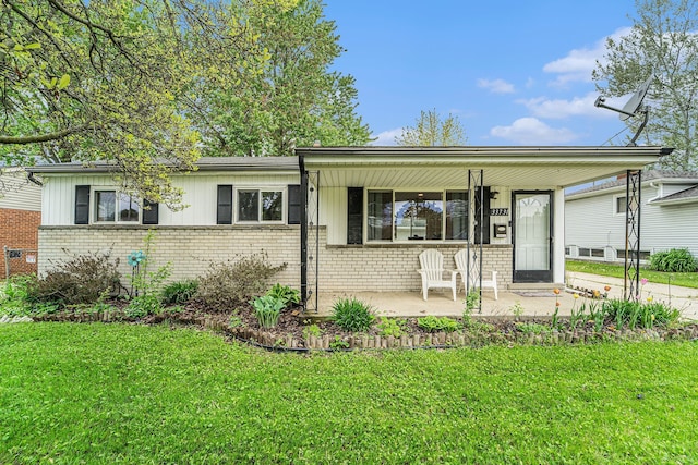 33731 Newport Dr, Sterling Heights, MI 48310 - ranch-style house featuring brick siding, a porch, and a front yard