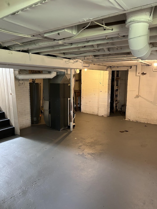 unfinished below grade area featuring stairway and heating unit