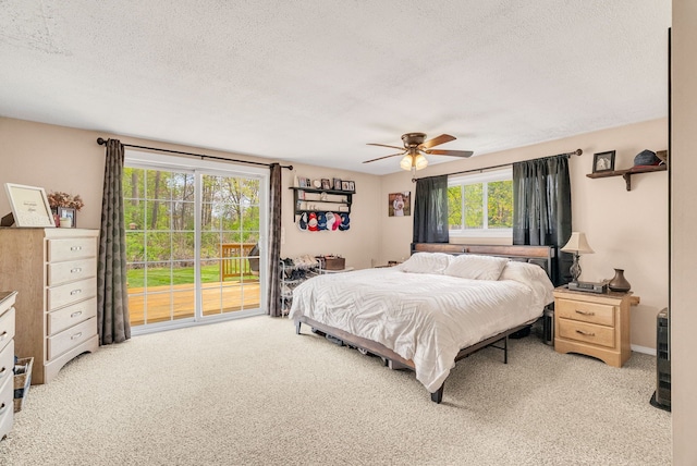 bedroom with light colored carpet, access to exterior, a textured ceiling, and ceiling fan