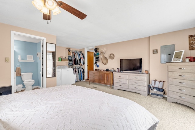 bedroom featuring separate washer and dryer, carpet flooring, electric panel, ensuite bathroom, and a spacious closet
