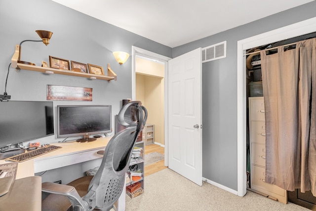 carpeted office space featuring baseboards