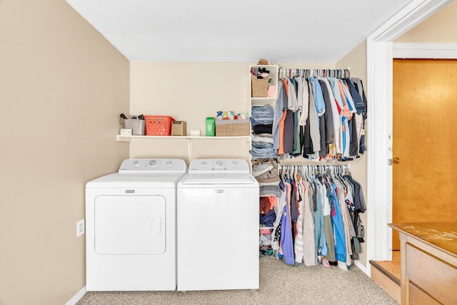 washroom with washer and clothes dryer, carpet floors, and baseboards
