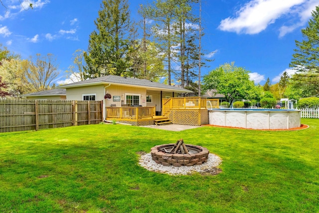 rear view of house featuring a deck and an outdoor fire pit