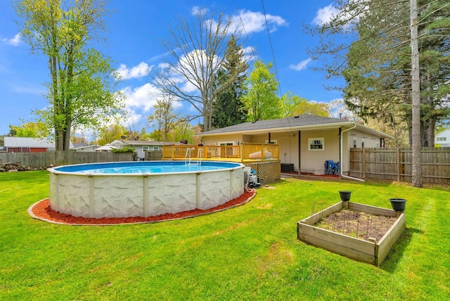 view of pool with a garden and a wooden deck