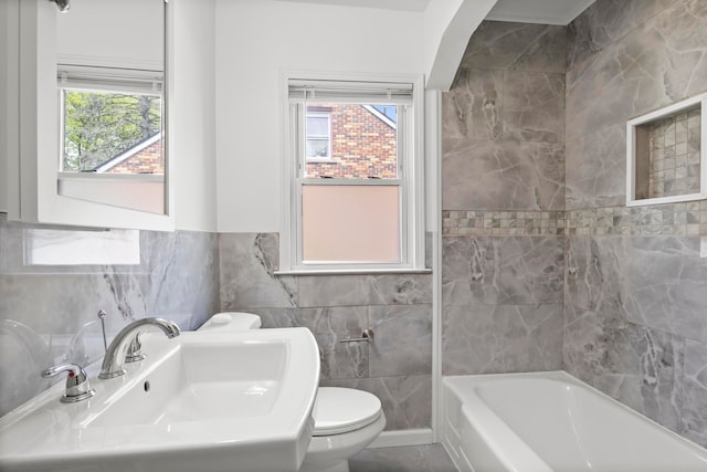 8105 Bramell, Redford, MI 48239 - bathroom featuring a sink, tile walls, a tub, toilet, and wainscoting