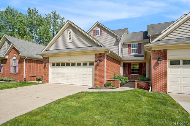 235 Cherry Stone Dr Unit 16, Canton, MI 48188 - traditional-style house featuring driveway, an attached garage, brick siding, and a front yard