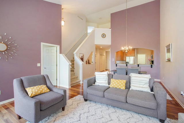 235 Cherry Stone Dr Unit 16, Canton, MI 48188 - living area with a chandelier, a high ceiling, wood finished floors, stairs, and baseboards