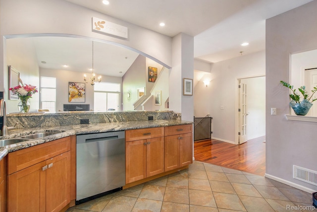 235 Cherry Stone Dr Unit 16, Canton, MI 48188 - kitchen with dishwasher, a chandelier, a sink, arched walkways, and light tile patterned floors