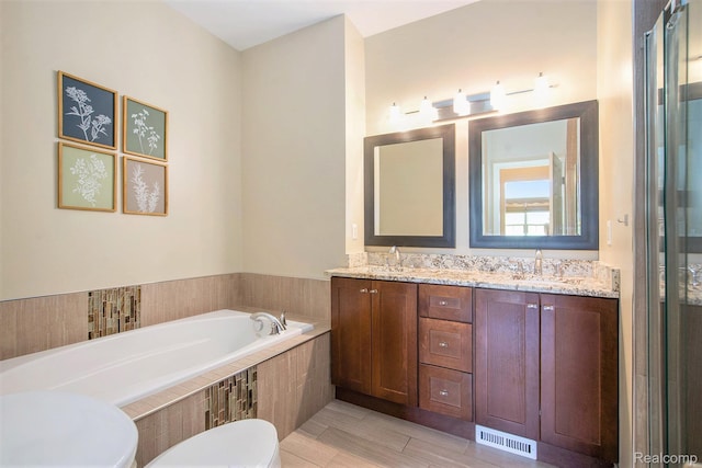 235 Cherry Stone Dr Unit 16, Canton, MI 48188 - bathroom featuring a garden tub, double vanity, and toilet