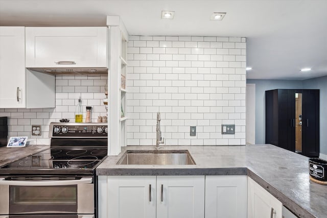 1812 Orchard St, Ann Arbor, MI 48103 - kitchen featuring stainless steel electric stove, a sink, white cabinetry, decorative backsplash, and recessed lighting