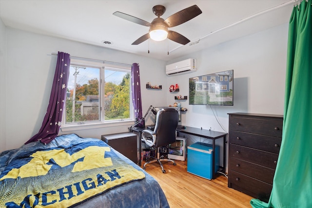 1812 Orchard St, Ann Arbor, MI 48103 - bedroom featuring wood finished floors, an AC wall unit, an office area, and a ceiling fan