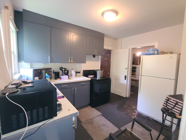 1814 Jasmine Ave, Flint, MI 48503 - kitchen with black appliances, light countertops, and gray cabinetry