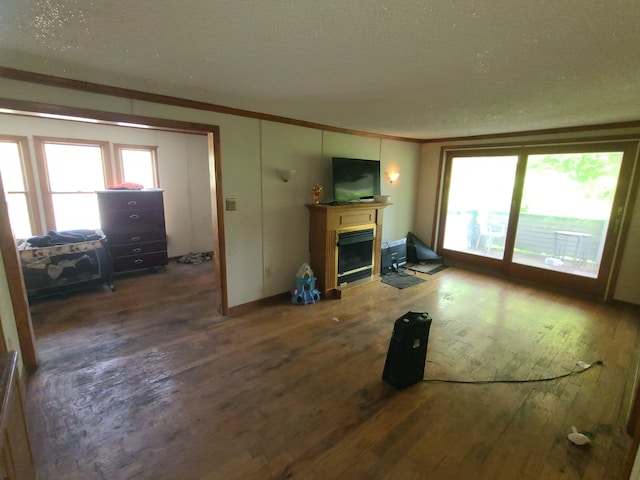1814 Jasmine Ave, Flint, MI 48503 - unfurnished living room with a fireplace with flush hearth, hardwood / wood-style floors, plenty of natural light, crown molding, and a textured ceiling