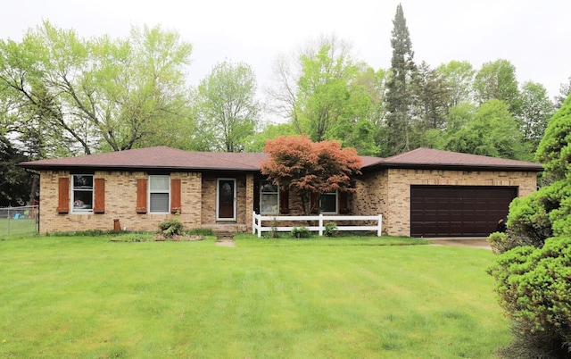 6452 Brian Circle Ln, Burton, MI 48509 - ranch-style house featuring brick siding, a garage, and driveway