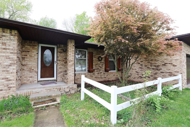 6452 Brian Circle Ln, Burton, MI 48509 - doorway to property featuring fence and brick siding