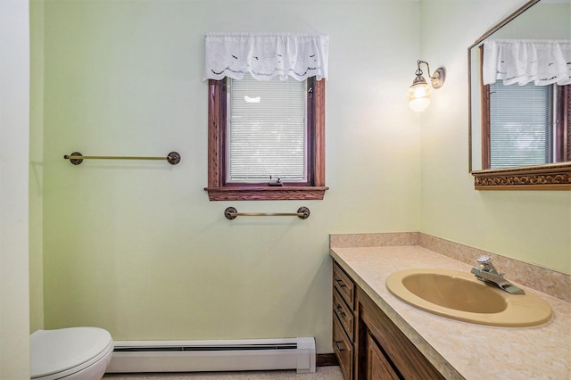 200 Brink St, Grant, MI 49327 - bathroom featuring baseboard heating, toilet, and vanity