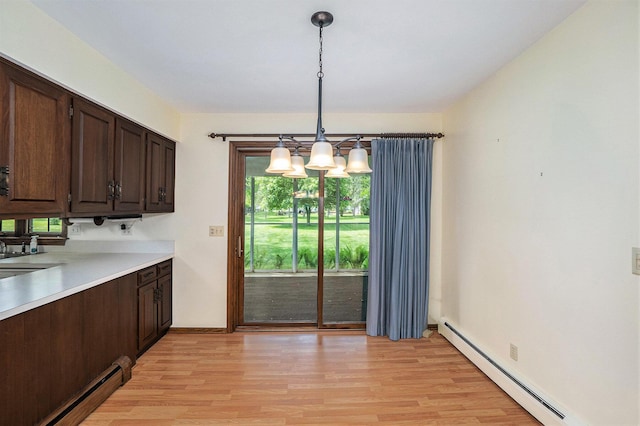 200 Brink St, Grant, MI 49327 - kitchen featuring a baseboard radiator, light wood-style floors, and a chandelier