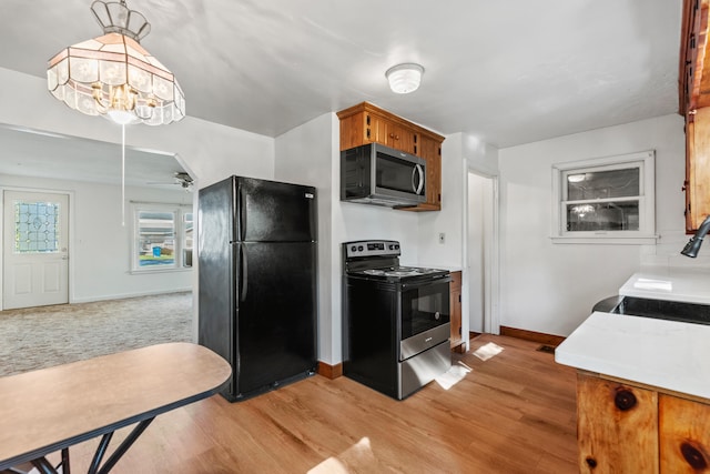 434 Walnut St, Howard City, MI 49329 - kitchen with freestanding refrigerator, electric range oven, stainless steel microwave, baseboards, and a sink