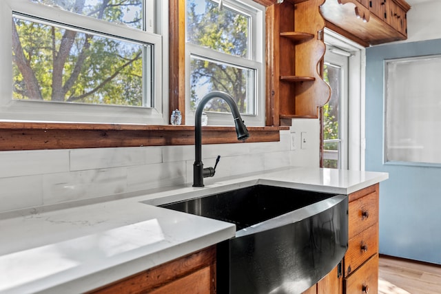 434 Walnut St, Howard City, MI 49329 - kitchen with a sink, open shelves, brown cabinets, and healthy amount of natural light