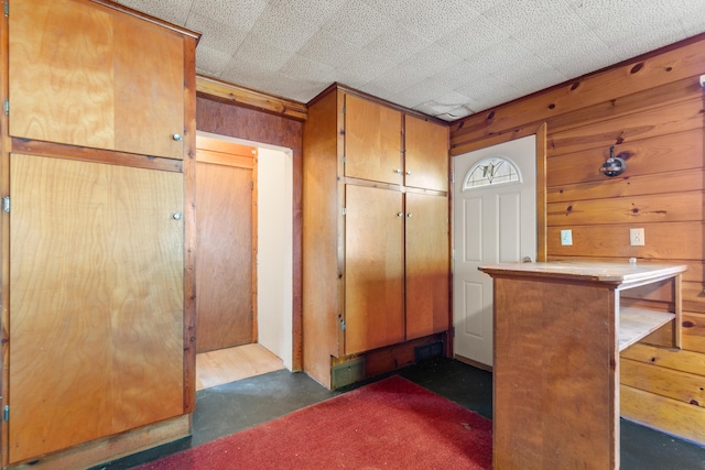 434 Walnut St, Howard City, MI 49329 - foyer entrance featuring wooden walls and finished concrete floors