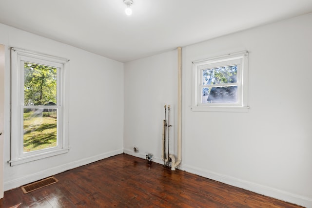 434 Walnut St, Howard City, MI 49329 - empty room with dark wood-style floors and baseboards