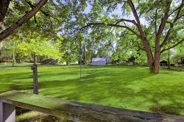 434 Walnut St, Howard City, MI 49329 - view of grassy yard with an outdoor structure and a shed