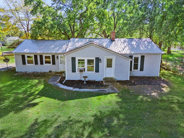 434 Walnut St, Howard City, MI 49329 - rear view of property with a yard, a chimney, metal roof, and entry steps