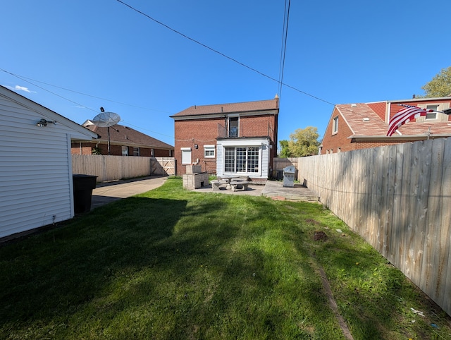9864 E Outer Dr, Detroit, MI 48224 - back of house featuring a patio and brick siding
