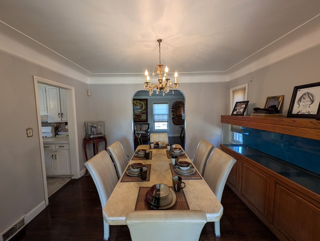 9864 E Outer Dr, Detroit, MI 48224 - dining space featuring arched walkways, a chandelier, and dark wood-style flooring