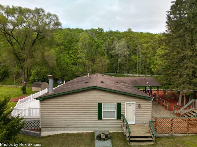 5705 Centerline Rd, Newaygo, MI 49337 - view of front of house featuring a deck and a view of trees