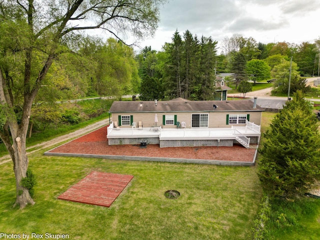 5705 Centerline Rd, Newaygo, MI 49337 - rear view of house with a deck and a yard
