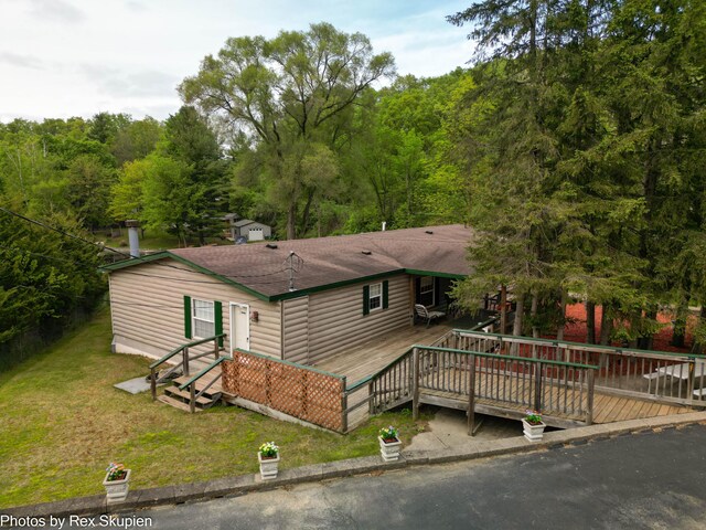 5705 Centerline Rd, Newaygo, MI 49337 - view of front of property with a front yard, a deck, and roof with shingles