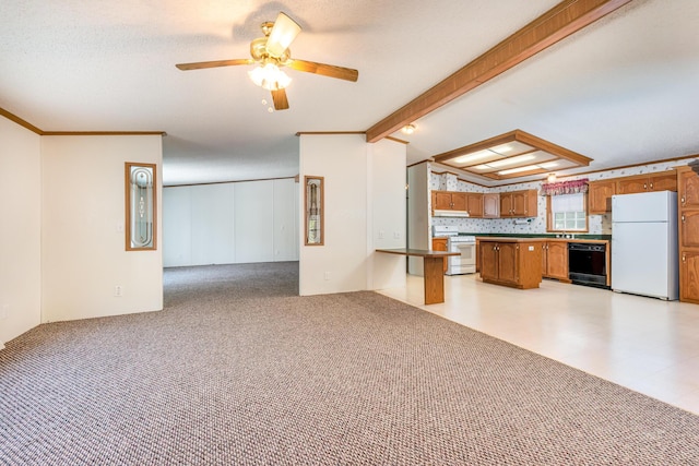 5705 Centerline Rd, Newaygo, MI 49337 - kitchen with white appliances, open floor plan, brown cabinetry, ceiling fan, and a peninsula
