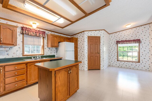 5705 Centerline Rd, Newaygo, MI 49337 - kitchen featuring ornamental molding, freestanding refrigerator, wallpapered walls, a sink, and a kitchen island