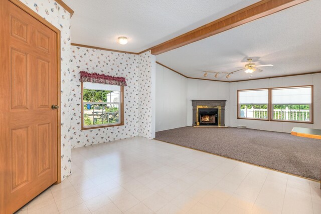 5705 Centerline Rd, Newaygo, MI 49337 - unfurnished living room with a textured ceiling, crown molding, wallpapered walls, ceiling fan, and a warm lit fireplace