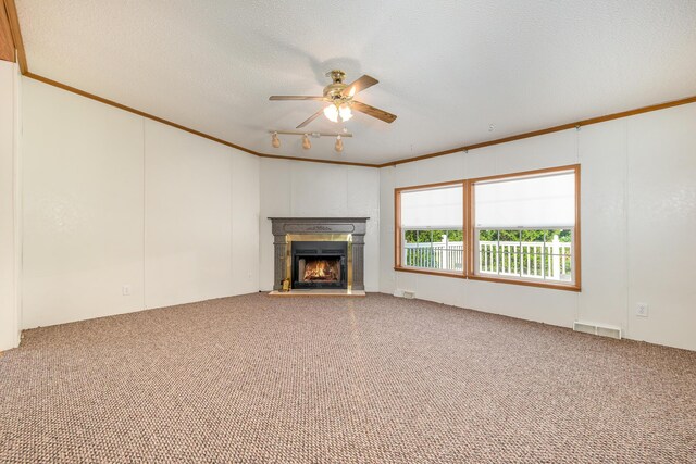 5705 Centerline Rd, Newaygo, MI 49337 - unfurnished living room featuring ceiling fan, carpet flooring, a warm lit fireplace, ornamental molding, and a textured ceiling