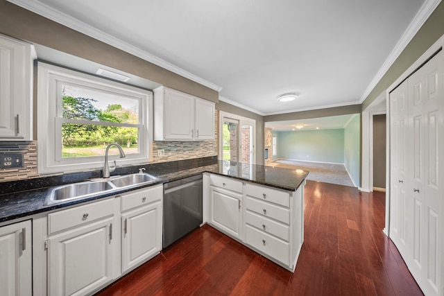 18080 Parke Ln, Grosse Ile, MI 48138 - kitchen with dishwasher, a sink, a peninsula, decorative backsplash, and crown molding